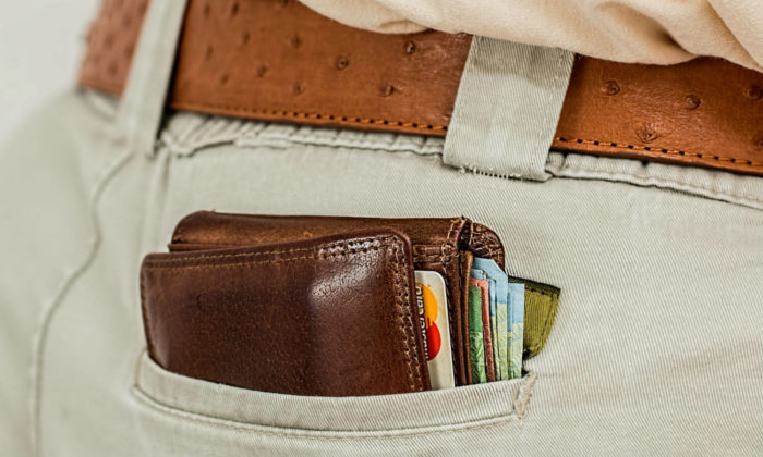 Wallet sticking out of a back pocket
