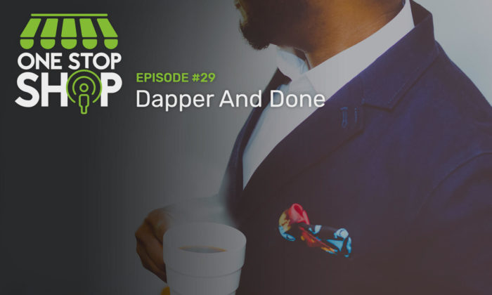 Episode #29 with Dapper & Done. Man holding a cup of steaming coffee dressed in a suit jacket with a colorful pocket square